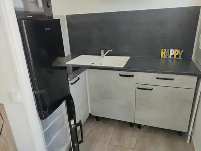 a small kitchen with a sink and a refrigerator at Studio rénové centre Gruissan - 2 pers, parking privé - FR-1-796-92 in Gruissan