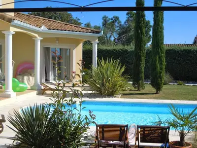 a patio with chairs and a couch on a porch at Villa 39 - Ariège in Le Vernet