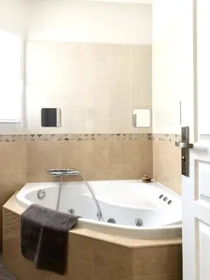 a white bedroom with a bed with two towels on it at Villa 39 - Ariège in Le Vernet