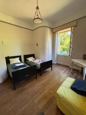 a room with two beds and a couch and a window at chateaubelleauboisdormant in Cambounet-sur-le-Sor