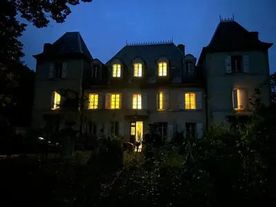 an old house with its lights on at night at chateaubelleauboisdormant in Cambounet-sur-le-Sor