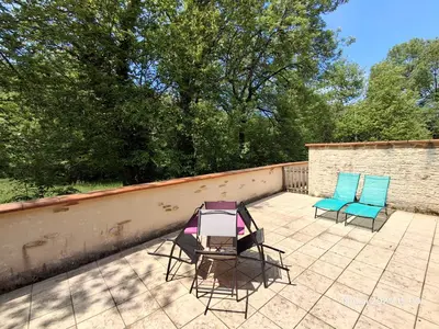 two chairs sitting on top of a patio at Gites Villa Robinson in Mazamet