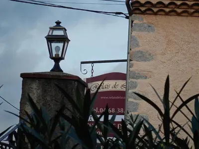 a street light in front of a building with a sign at Relais de Laval in Caudiès-de-Fenouillèdes