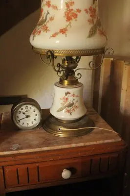 a lamp on a table next to a clock at - Atelier - in Villalier