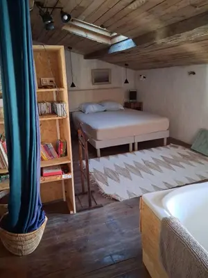 a bedroom with a bed and a book shelf at - Atelier - in Villalier