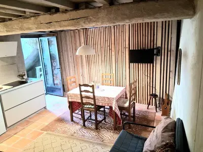 a kitchen with a table and chairs in a room at - Atelier - in Villalier