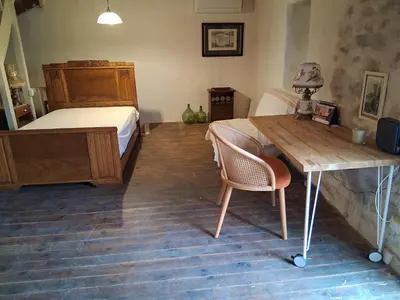 a bedroom with a bed and a desk and a table at - Atelier - in Villalier