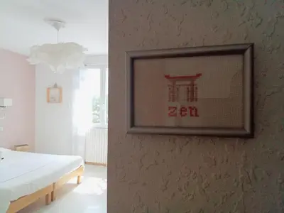 a picture frame hanging on a wall in a bedroom at Le Mauzac chambre Zen in Limoux