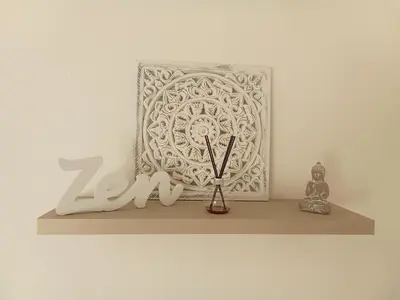 a shelf with a clock and a vase on it at Le Mauzac chambre Zen in Limoux