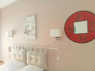 a living room with a white couch and a mirror at Le Mauzac chambre Zen in Limoux