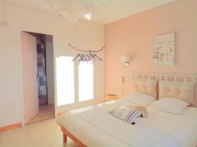 a bedroom with a white bed and a window at Le Mauzac chambre Zen in Limoux
