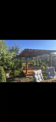 a gazebo with two white chairs and a table at Villa avec piscine à mirepoix in Mirepoix