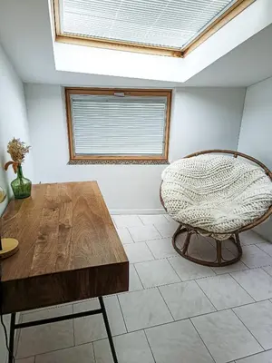 a room with a wooden table and a chair at Maison 4 pers, calme et confort in Opoul-Périllos