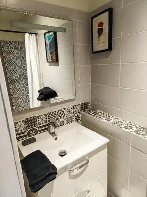a bathroom with a white sink and a mirror at Maison 4 pers, calme et confort in Opoul-Périllos