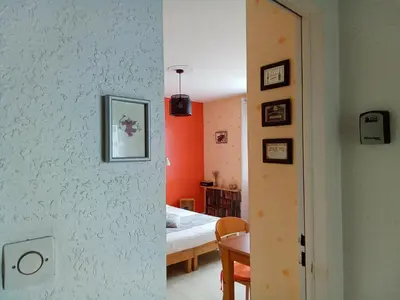 a room with a bedroom with a bed and a table at Chambre la Limouxine in Limoux