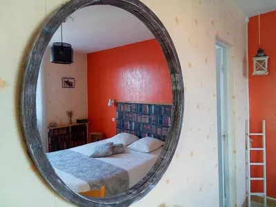 a mirror in a bedroom with a bed in it at Chambre la Limouxine in Limoux