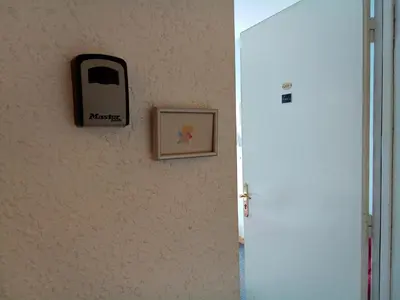 a picture of a cell phone hanging on a wall at Chambre Love in Limoux