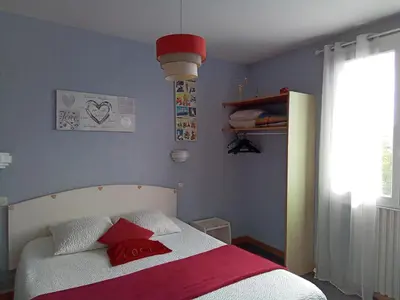 a bedroom with a bed with red and white pillows at Chambre Love in Limoux