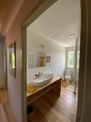 a bathroom with a sink and a toilet at En joia ! in Teyssode