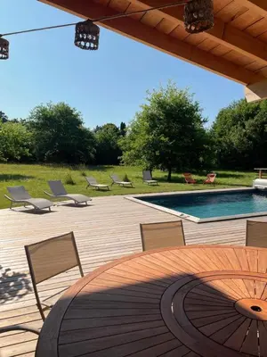 a patio with chairs and a swimming pool at En joia ! in Teyssode