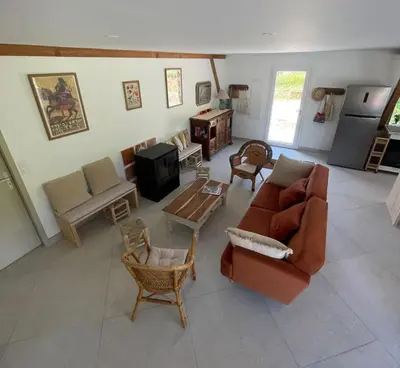 a living room with a couch and a table at En joia ! in Teyssode