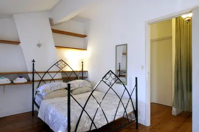 a bedroom with a black bed in a room at Maison de maître à BRAM # Jacuzzi in Bram