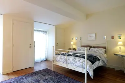 a bedroom with a bed and a window at Maison de maître à BRAM # Jacuzzi in Bram