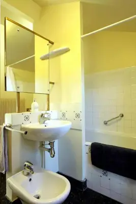 a bathroom with a sink and a mirror and a tub at Maison de maître à BRAM # Jacuzzi in Bram