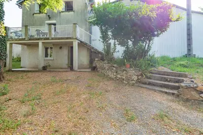 a house with a balcony and stairs in front of it at La Pause Verte - 30min de Castre in Montredon-Labessonnié