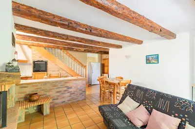 a living room with a couch and a table at La Pause Verte - 30min de Castre in Montredon-Labessonnié