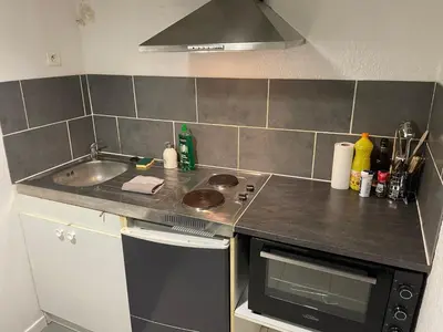 a small kitchen with a sink and a stove at Les Studios de la Bastide in Carcassonne