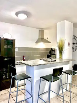 a kitchen with a counter and stools in a kitchen at Appartement Centre Ville in Carcassonne
