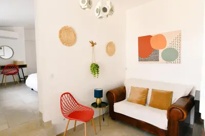 a living room with a couch and chairs at Maison La Djoon,Vue Cité, centre ville Spa Jardin in Carcassonne