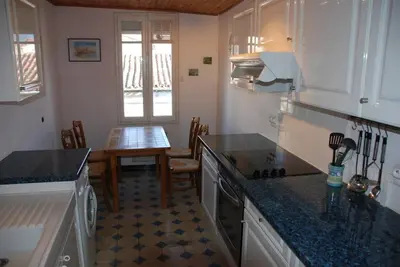 a kitchen with a table and a counter top at Pyrenees,Hiking, Cycling, Rafting,Fishing,4 Bed Apartment, Roof Terrace in Quillan