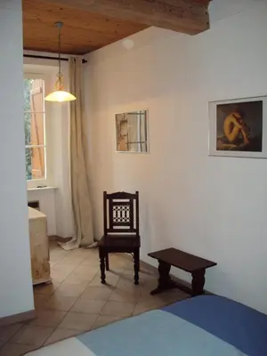 a room with a chair and a table and a bench at Pyrenees,Hiking, Cycling, Rafting,Fishing,4 Bed Apartment, Roof Terrace in Quillan