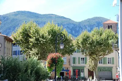 a street with trees and a street light with mountains in the background at Pyrenees,Hiking, Cycling, Rafting,Fishing,4 Bed Apartment, Roof Terrace in Quillan