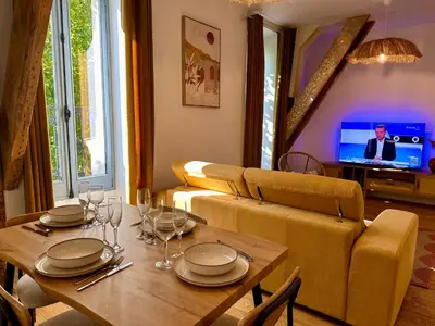 a living room with a table and a couch at Appartement T2 Méditerranéen in Narbonne