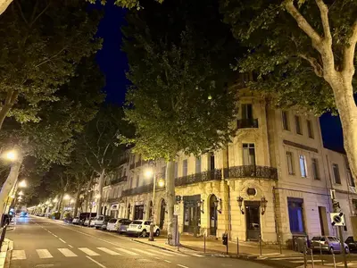 a city street at night with a building at Appartement T2 Méditerranéen in Narbonne