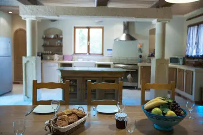 a kitchen with a table with a bowl of fruit at Gite Les 3F in Fontcouverte