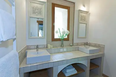 a bathroom with two sinks and two mirrors at Gite Les 3F in Fontcouverte