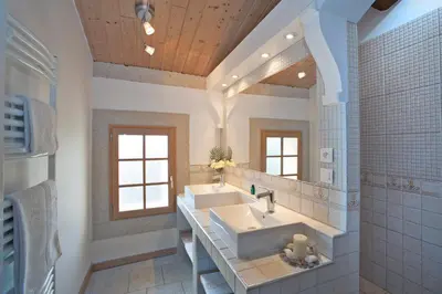 a bathroom with two sinks and a large mirror at Gite Les 3F in Fontcouverte
