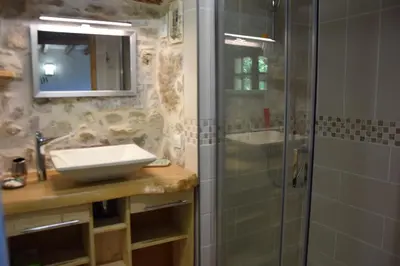 a bathroom with a sink and a shower with a mirror at gîte les Libellules in Saint-Salvy-de-la-Balme