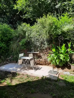 a table and two chairs sitting on a patio at gîte les Libellules in Saint-Salvy-de-la-Balme