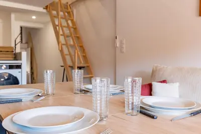 a dining room table with plates and glasses on it at La Cité Merveilleuse - Cité - Clim - Wifi in Carcassonne