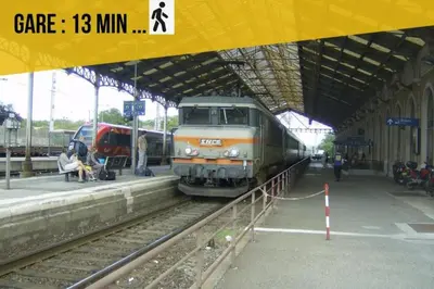 a train on the tracks at a train station at La Cité Merveilleuse - Cité - Clim - Wifi in Carcassonne
