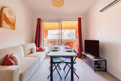 a living room with a couch and a table at La Cité Merveilleuse - Cité - Clim - Wifi in Carcassonne