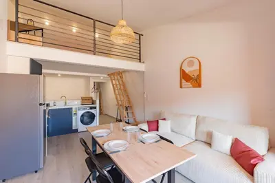 a living room with a couch and a table at La Cité Merveilleuse - Cité - Clim - Wifi in Carcassonne