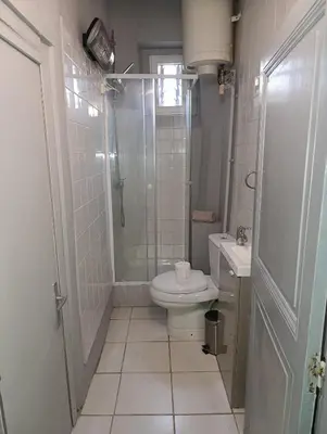 a bathroom with a shower and a toilet and a sink at Good Knight Inn in Carcassonne