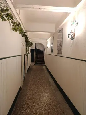 a long hallway with a staircase in a building at Good Knight Inn in Carcassonne
