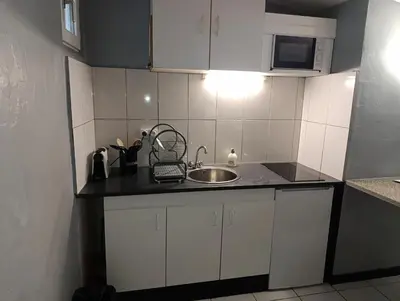 a kitchen with a sink and a counter top at Good Knight Inn in Carcassonne